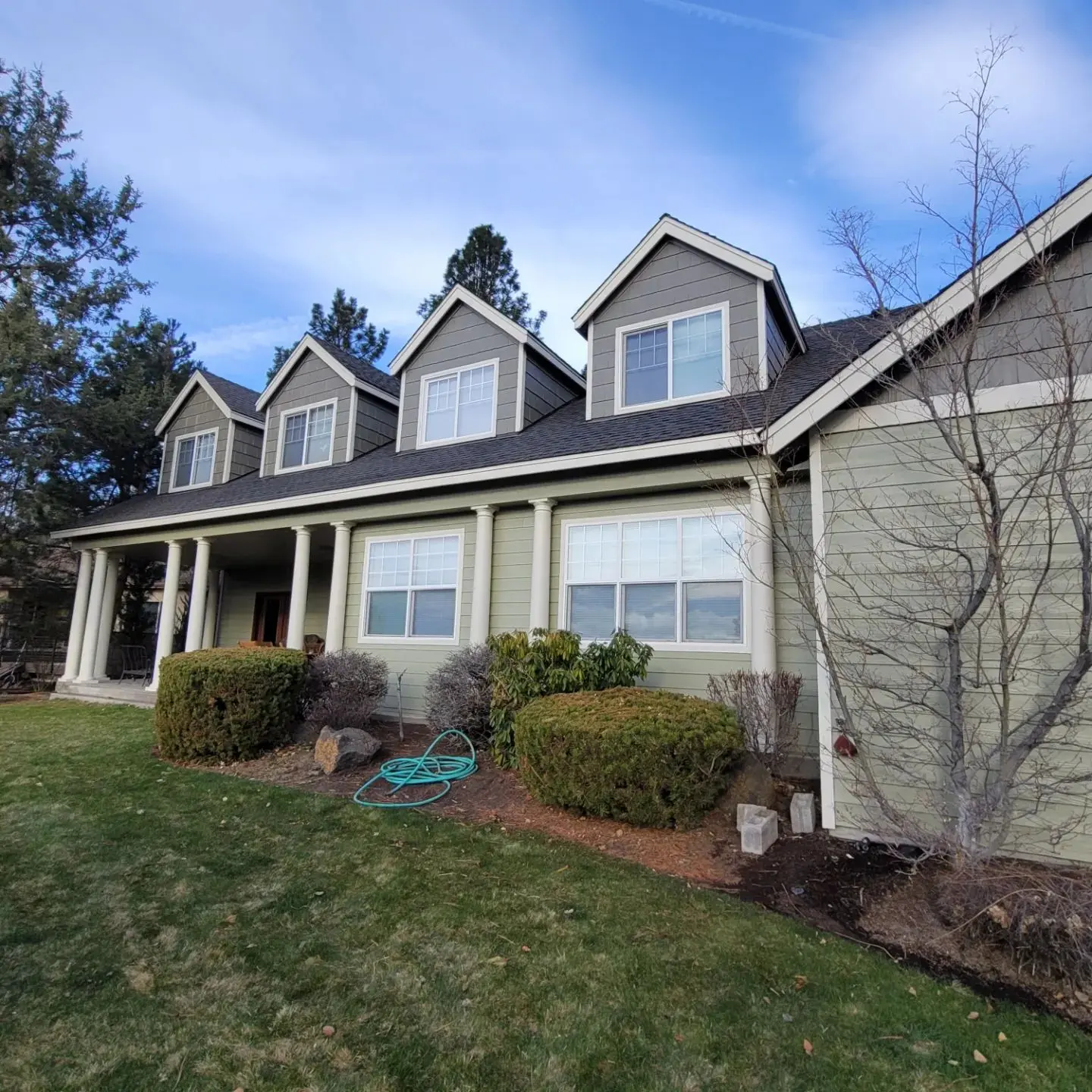 Front porch detail in Bend featuring classic white pillars and a clean white trim package.