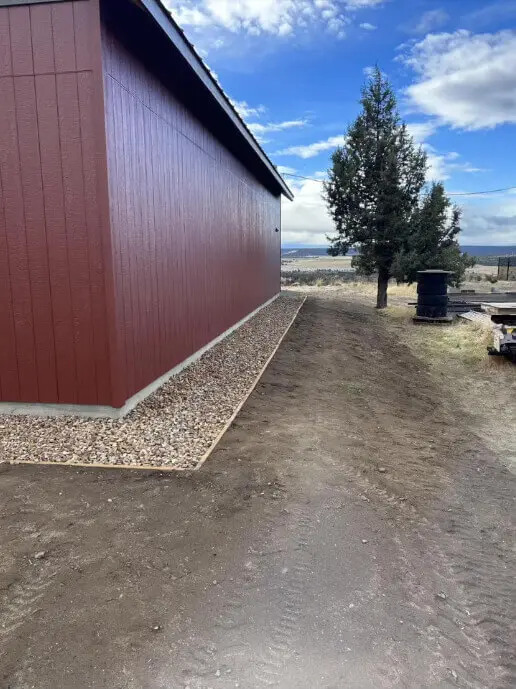 Detailed view of crisp paint lines on vertical siding above a gravel border.