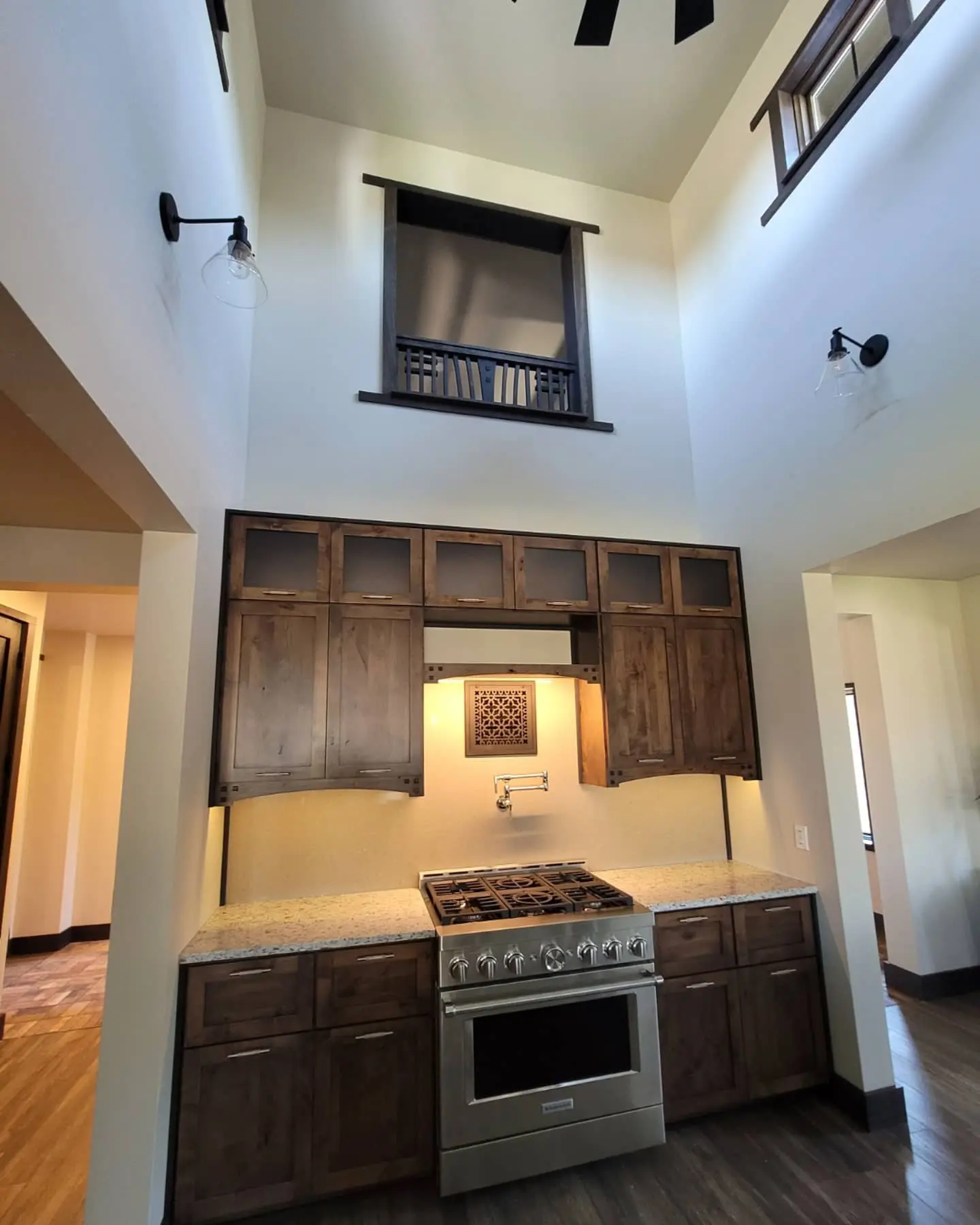 Gourmet kitchen in Redmond with custom-stained dark wood cabinets, granite countertops, and high-end stainless steel appliances.