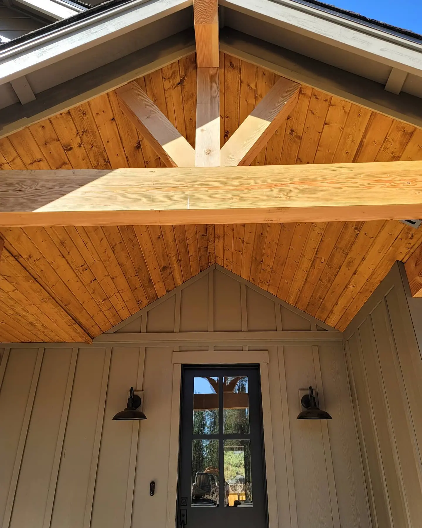 Detailed shot of structural wood beams and a gabled ceiling in Sisters freshly treated with a transparent wood finish.