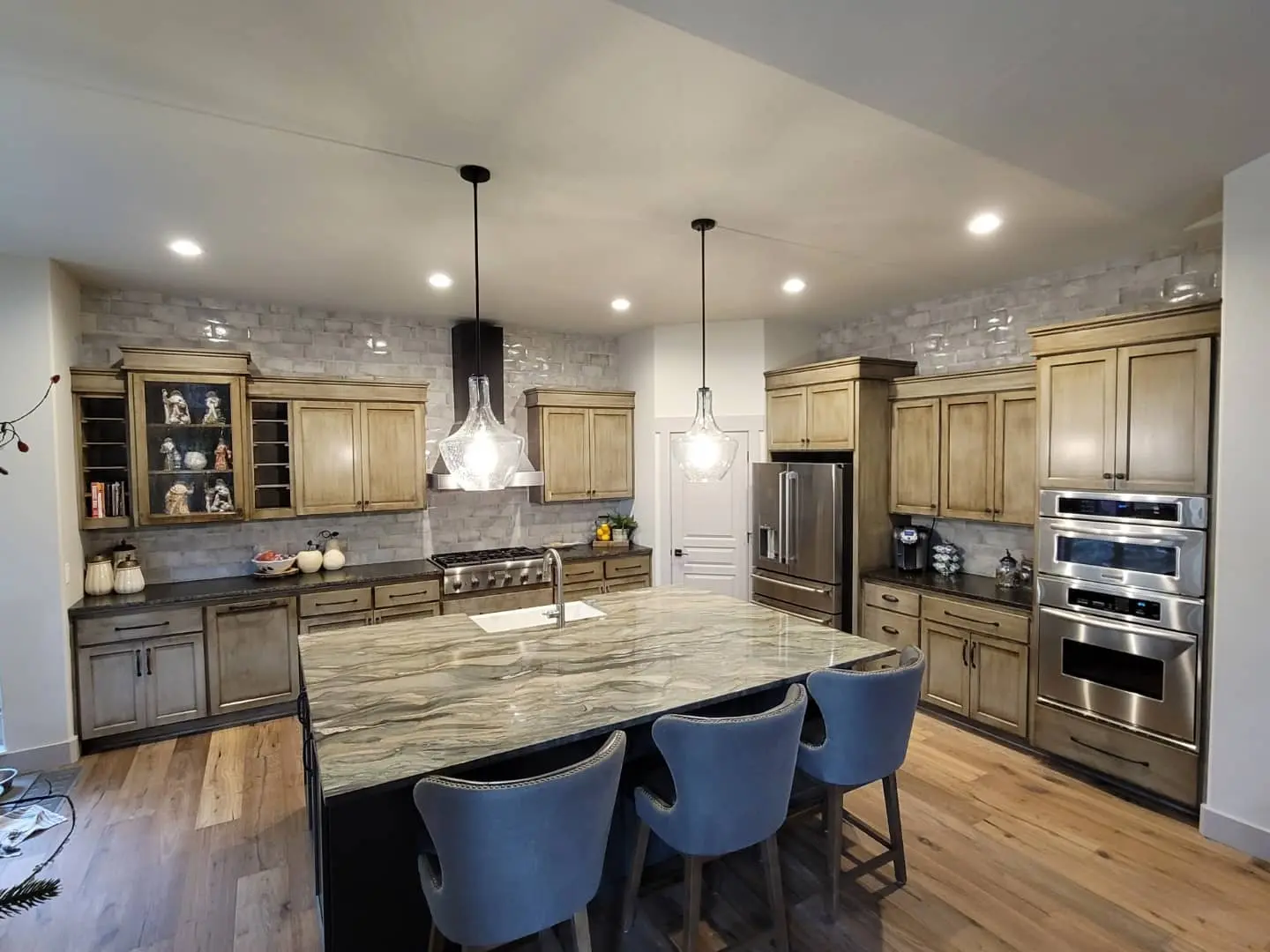 Final transformation of an Eagle Crest kitchen with refinished cabinets, island, and new lighting.
