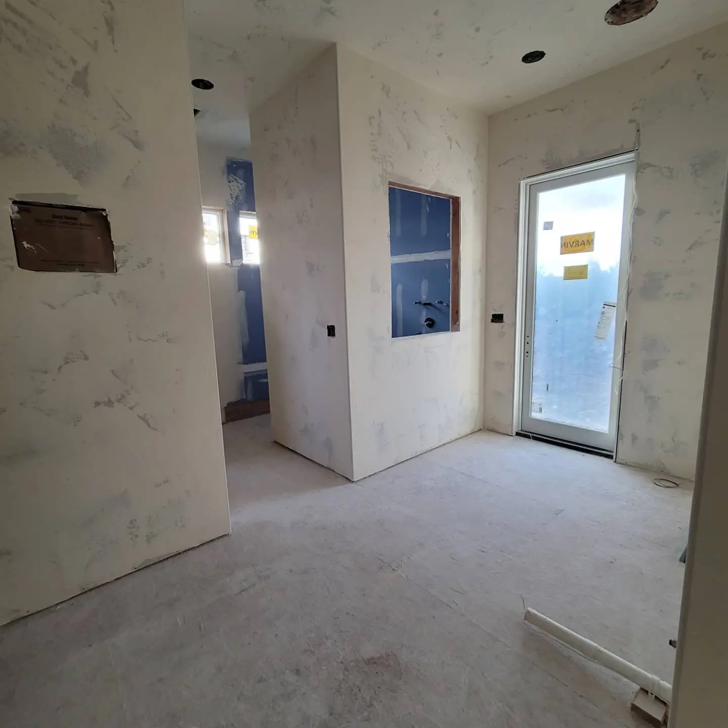 Utility room or mudroom area with finished drywall texture ready for professional coating.