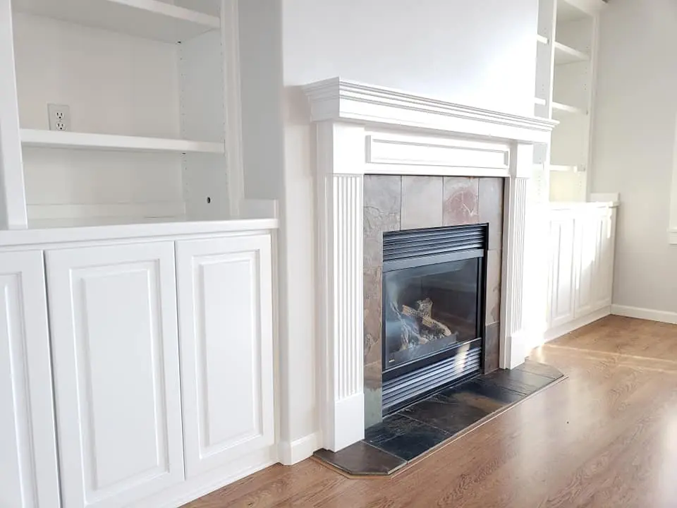 Close-up detail of a white enamel mantle showcasing smooth texture and sharp architectural lines.