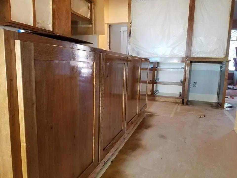 Close-up of a high-gloss protective finish applied to custom wood cabinetry.