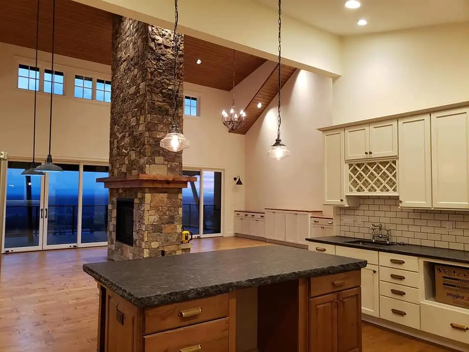 Wide angle view of a finished open-concept kitchen and living area in Brasada Ranch, Oregon.