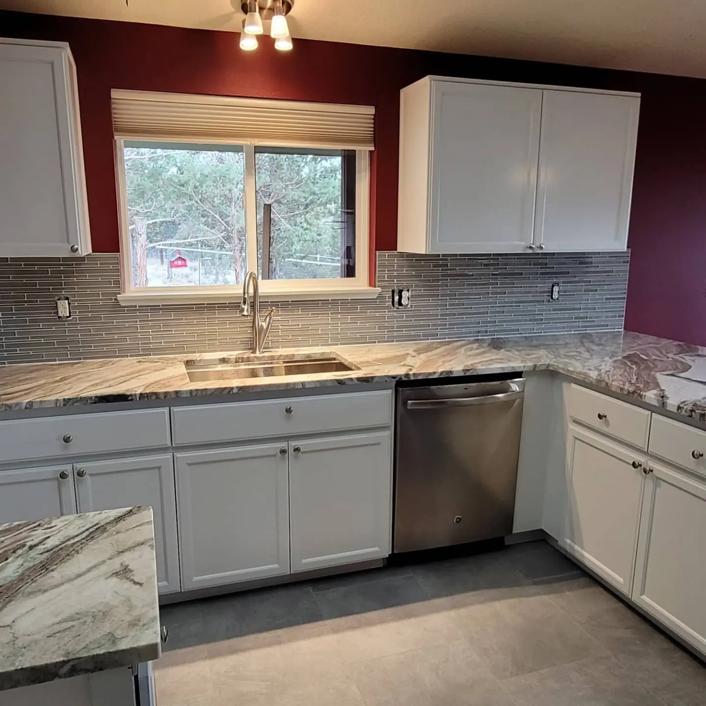 Completed kitchen cabinetry in Powell Butte showing a bright white finish and updated hardware.