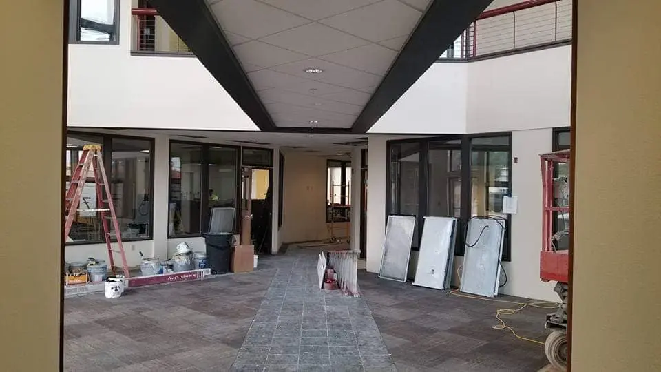 Lobby area of Redmond Proficiency Academy during painting with ladders and equipment set up for professional interior services