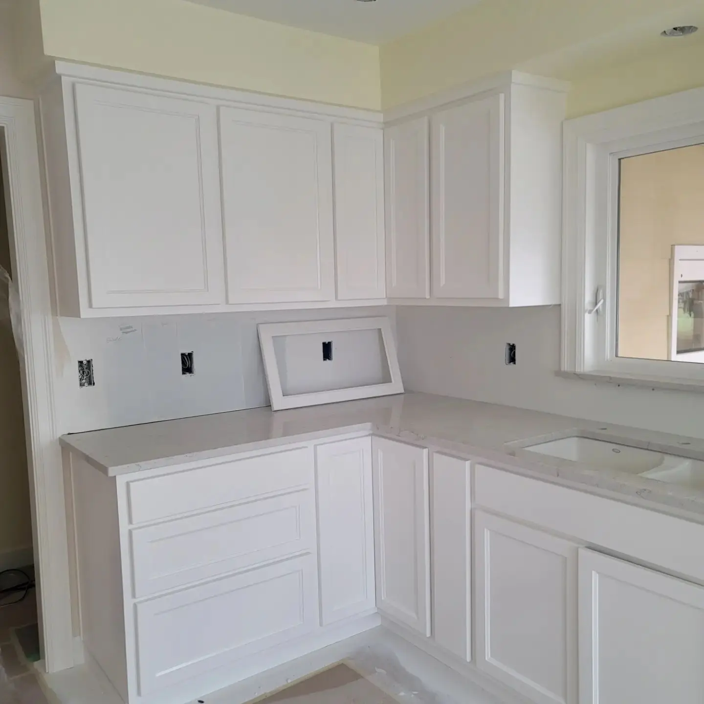 View of the original oak kitchen cabinetry and breakfast bar in Salem before professional painting.