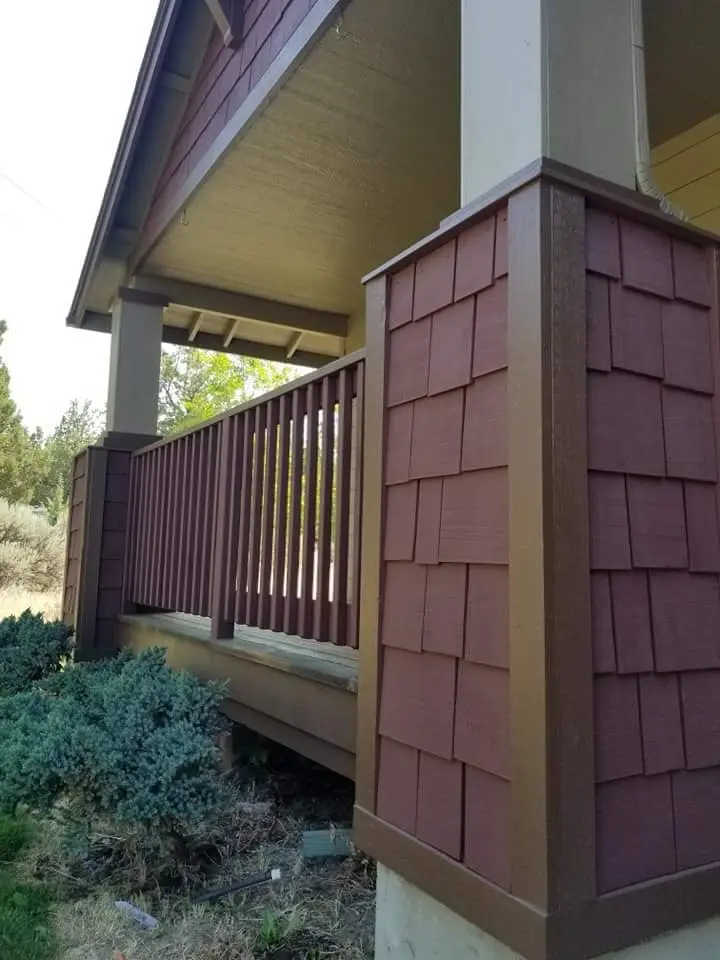Detailed view of painted burgundy shingle siding on a porch pillar in Madras.