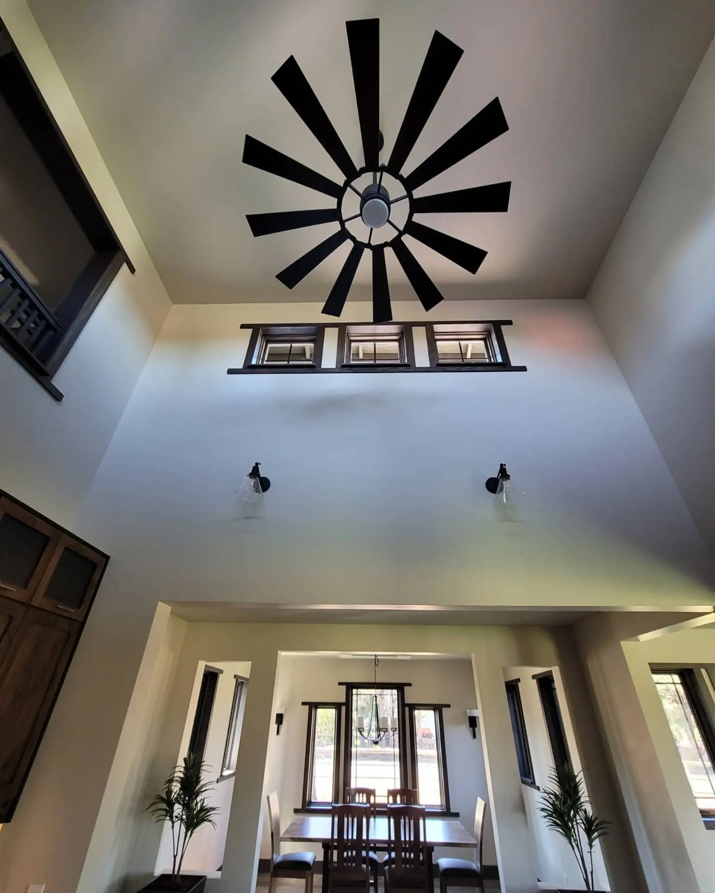 Grand living area in Redmond featuring high vaulted ceilings, a large black windmill ceiling fan, and clerestory windows.