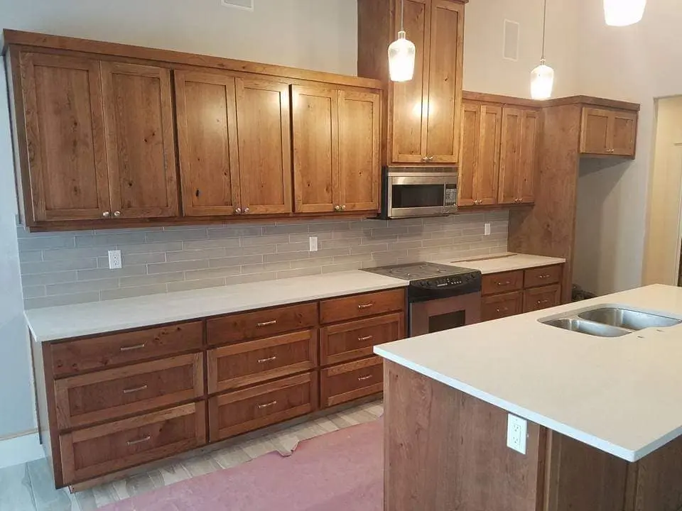Close-up of uniform stain application on residential kitchen cabinetry in Central Oregon.